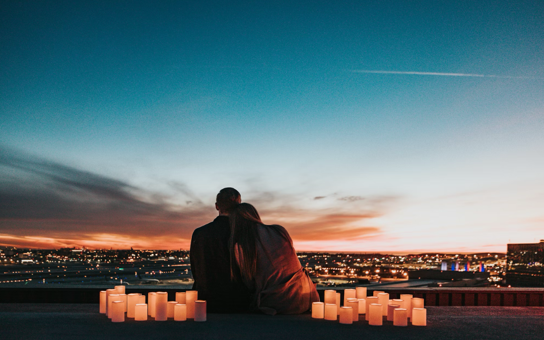Couple enjoying sunset with candles, ymbolising intimacy, emotional connection, and real love beyond Valentine’s Day pressure